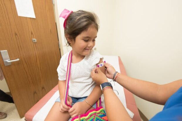 A young girl receiving a vaccine at a clinic — Kenya Travel Vaccinations for children before international trips. A-young-girl-receiving-a-vaccine-at-a-clinic — Kenya -Travel Vaccinations-for-children-before-international trips.