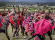 maasai-men-in-red-shukas-perform-traditional-ceremony-with-dancing-and-sticks-in-kenya