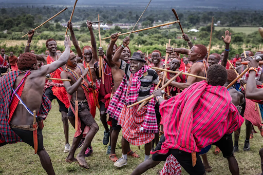 maasai-men-in-red-shukas-perform-traditional-ceremony-with-dancing-and-sticks-in-kenya
