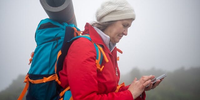Solo female traveler checking phone for directions Solo-female-traveler-checking-phone-for-directions