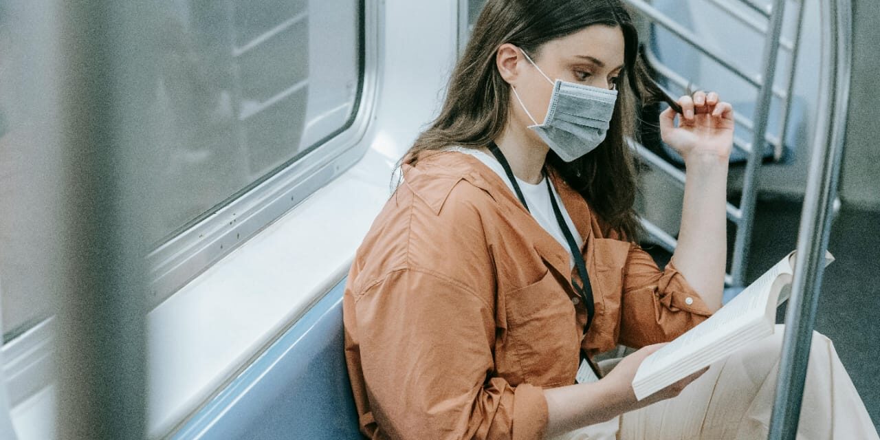 A lady in a train reading a book A-lady-in-a-train-reading-a-book