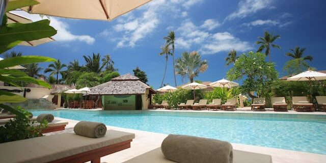 Luxury lodge in Kenya with poolside loungers and palm trees Luxury-lodge-in-Kenya-with-poolside-loungers-and-palm-trees