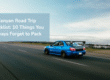 Blue-car-driving-on-an-open-road-during-a-road-trip
