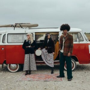 Friends-taking-a-break-during-a-road-trip-relaxing-by-the-roadside