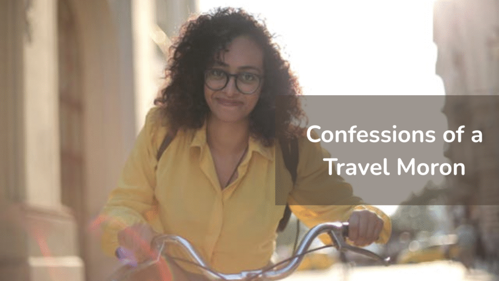 Woman-in-yellow-shirt-with-glasses-smiling-while-holding-bicycle-handlebars-outdoors