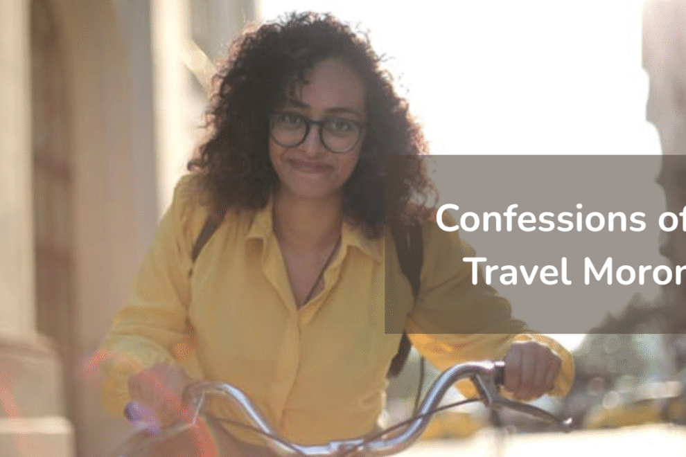 Woman in yellow shirt with glasses smiling while holding bicycle handlebars outdoors Woman-in-yellow-shirt-with-glasses-smiling-while-holding-bicycle-handlebars-outdoors